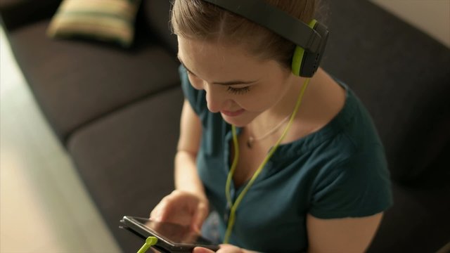 Woman With Mobile Phone Listens Music Podcast Earphones