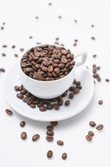 cup with coffee beans isolated on white background.