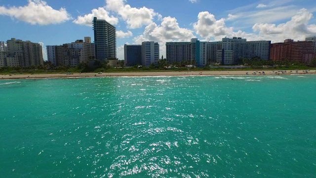 Aerial video flying over the ocean to Miami Beach