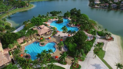 Aerial video of people swimming in a community pool