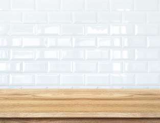 Empty wood table and  white ceramic tile brick wall in backgroun