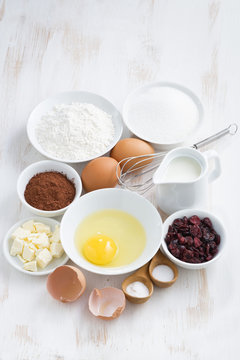 fresh ingredients for baking on white table, vertical, top view
