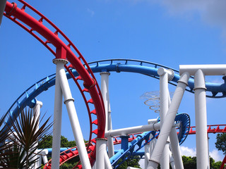 a roller coaster's loop with blue sky