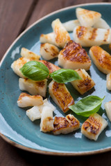 Close-up of grilled pineapple slices with green basil leaves