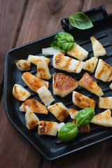 Cast-iron grill with roasted pineapple slices, close-up
