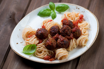 Meatballs with tomato sauce and spaghetti, selective focus