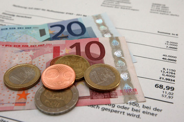 Euro notes and coins on invoice