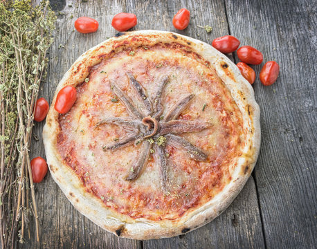 Anchovies  pizza on wooden table