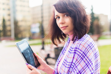 Fototapeta premium Beautiful woman in town using electronic tablet