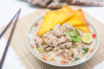 white noodles with meatballs and fried wonton