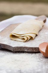 Homemade spaghetti, pasta or noodles on wooden table. 