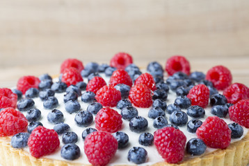 Cake with blueberries and raspberries. Confectionery product.