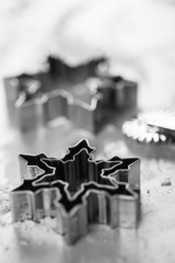 Gingerbread metallic snowflake form on white table, soft focus