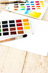 Workplace artist - paper, paint, brushes, color wheel