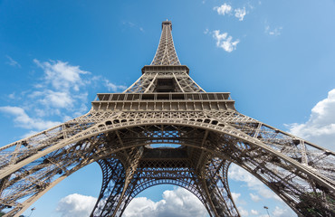 The Eiffel Tower over blue sky, bottom-up view