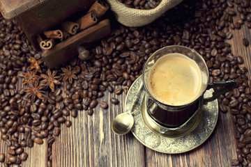 Coffee cup and beans, old coffee grinder and canvas sack