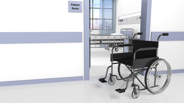 Black disability wheelchair in front of patient room in hospital