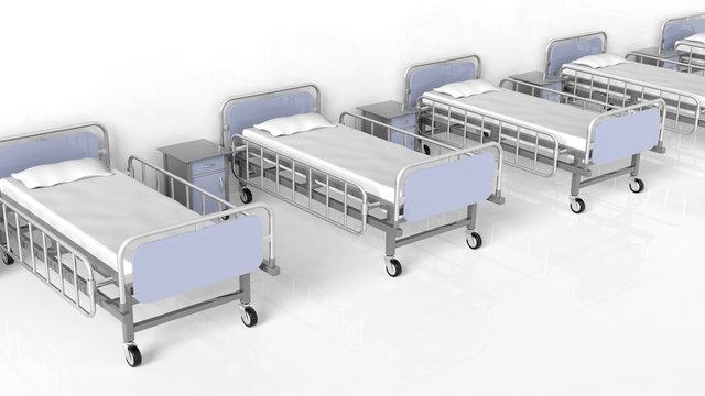 Hospital Beds And Bedside Tables In A Row