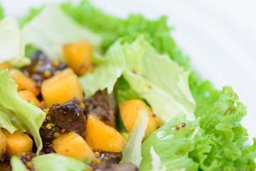 salad with meat and basil leaves