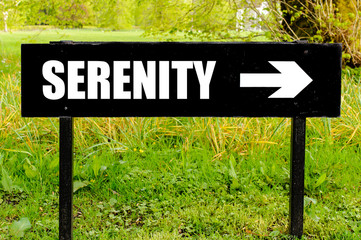 SERENITY written on directional black metal sign