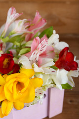 Beautiful spring flowers on wooden background