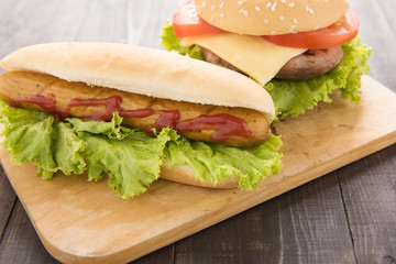 Hot dogs,hamburgers on the wooden background.