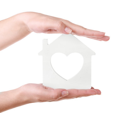 Female hands with small model of house isolated on white