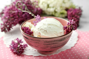 Beautiful composition with tasty ice cream and lilac flowers