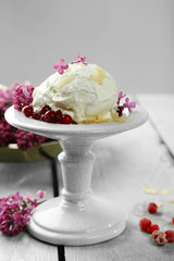 Beautiful composition with tasty ice cream and lilac flowers