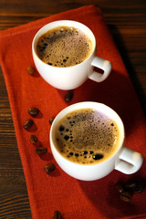 Cups of coffee on napkin on table close up