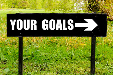 YOUR GOALS written on directional black metal sign