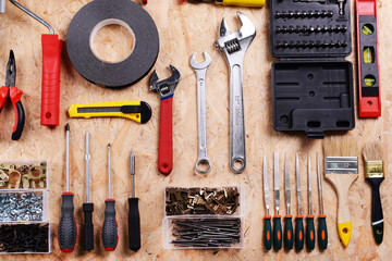 Set of tools on plywood, top view