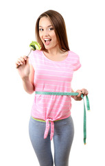 Fototapeta na wymiar Healthy young woman with vegetables on fork and measuring tape isolated on white