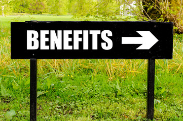 BENEFITS written on directional black metal sign