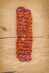 Sliced fuet with red pepper. Top view.