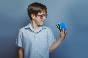 a boy of 10 years of European appearance with glasses holding kr