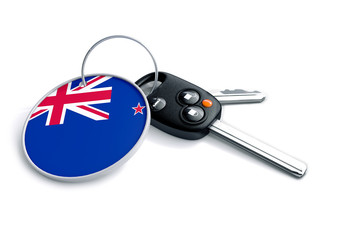Set of car keys with keyring and country flag. Concept for car prices, buyer or selling a vehicle in New Zealand