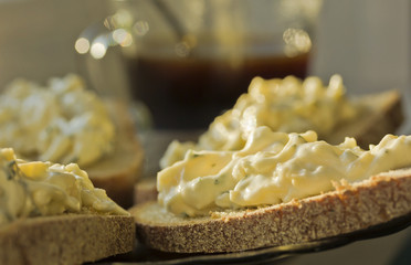   Sandwiches on rye bread with cheese and garlic appetizer.