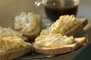  	  Rye bread with cheese and garlic appetizer and coffee.