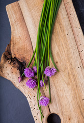 Bunch of fresh chives on a wooden table
