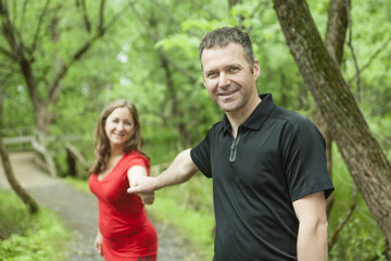 Fototapeta premium A couple standing on forest trail