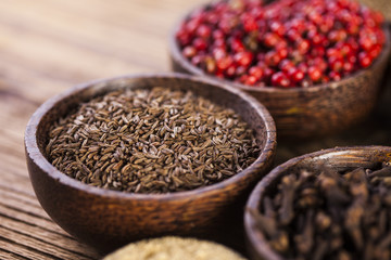 Spices and herbs in wooden bowls