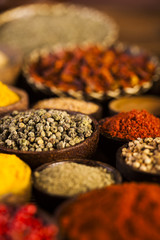 Spices and herbs in wooden bowls
