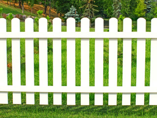White fence in garden.