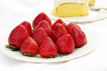  Fresh Strawberries on plate with cake on side, selective focus