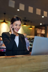 business woman laptop cafe cellphone