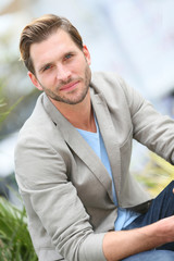 Handsome guy sitting in the street