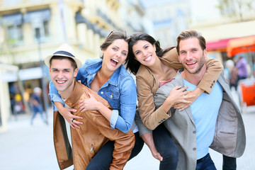 Obraz premium Group of friends getting silly in shopping street