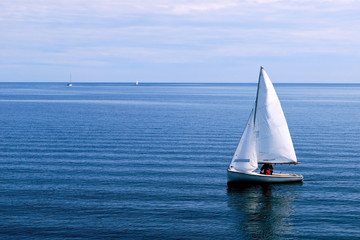 White Sailboat in the blue Ocean