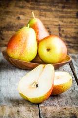 Three fresh ripe organic pears and sliced one